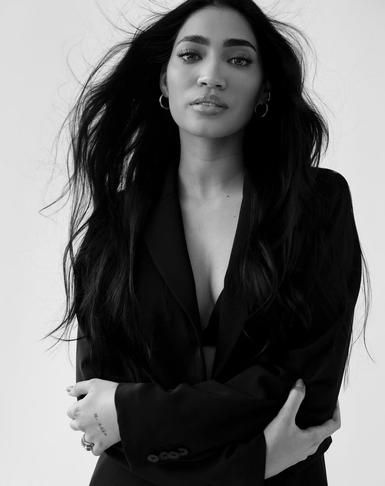 Black-and-white portrait with long dark hair and black blazer — makeup by Rebecca Lee Artistry