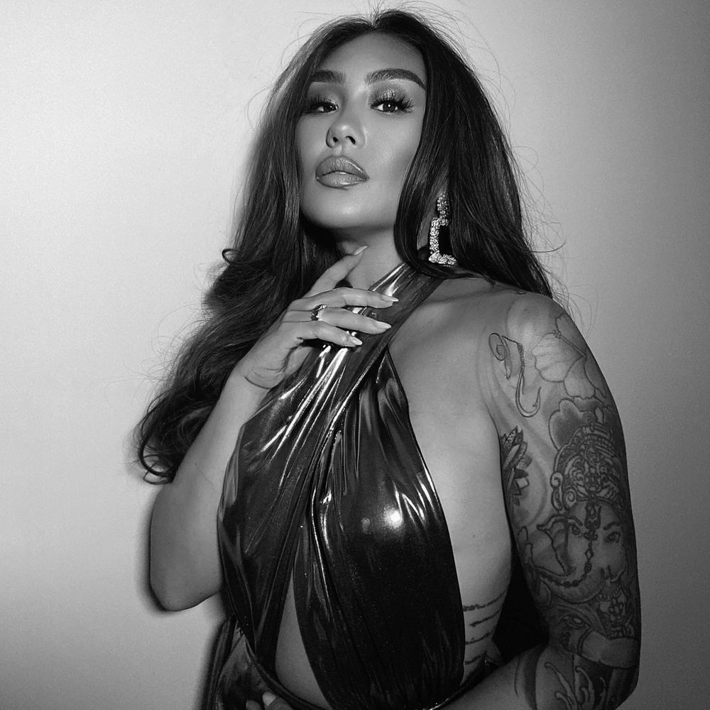 Rebecca Lee — black-and-white portrait with long dark hair and a tattooed arm, makeup by Rebecca Lee Artistry, from rebeccaleeartistry.com