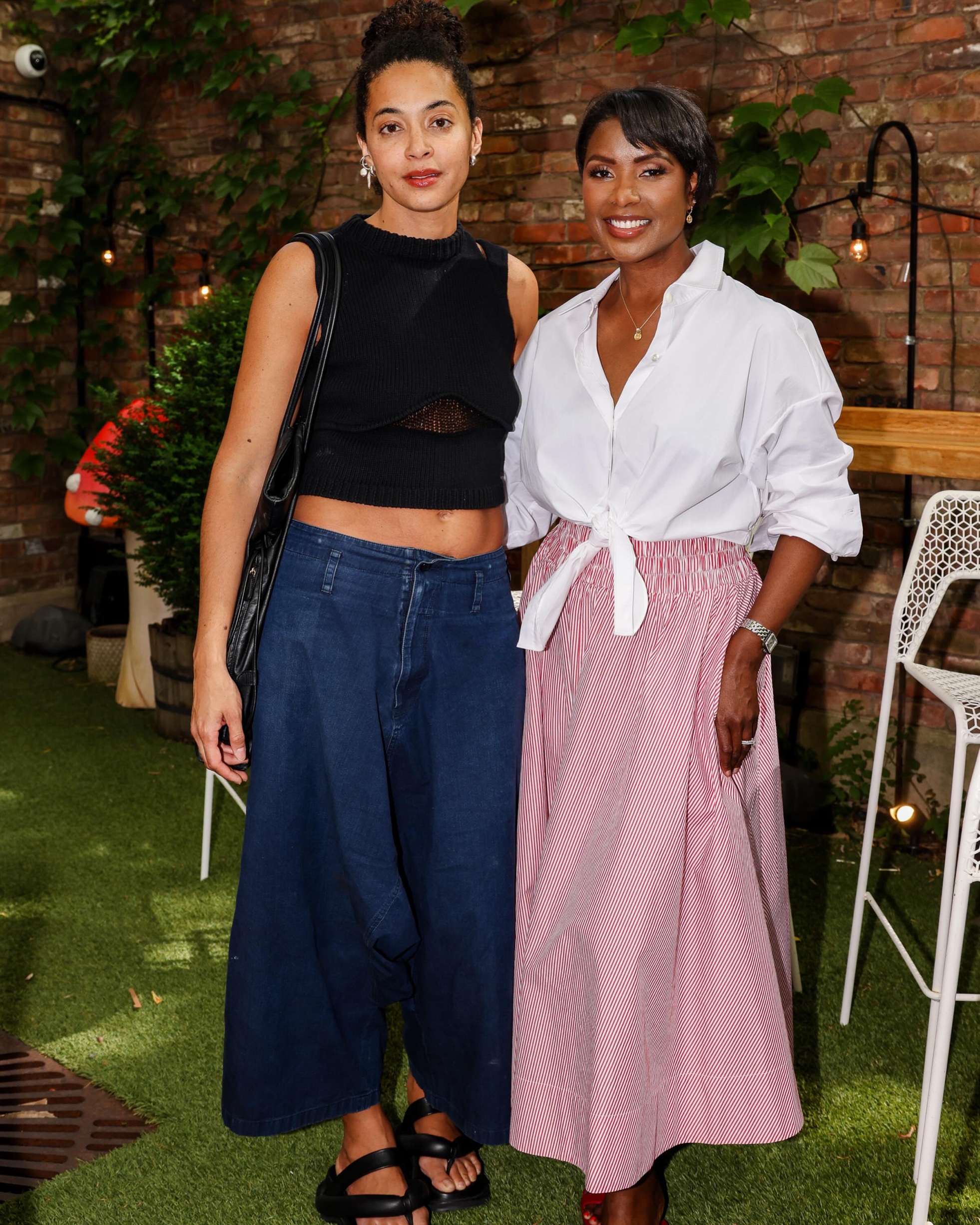 Two guests at a RAISE Fashion event, makeup by Rebecca Lee Artistry